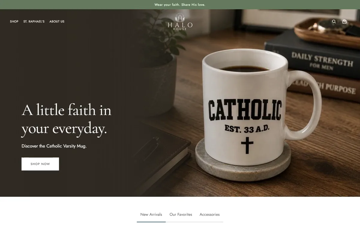 The Halo House storefront homepage on desktop: the headline A little faith in your everyday beside the Catholic Varsity Mug